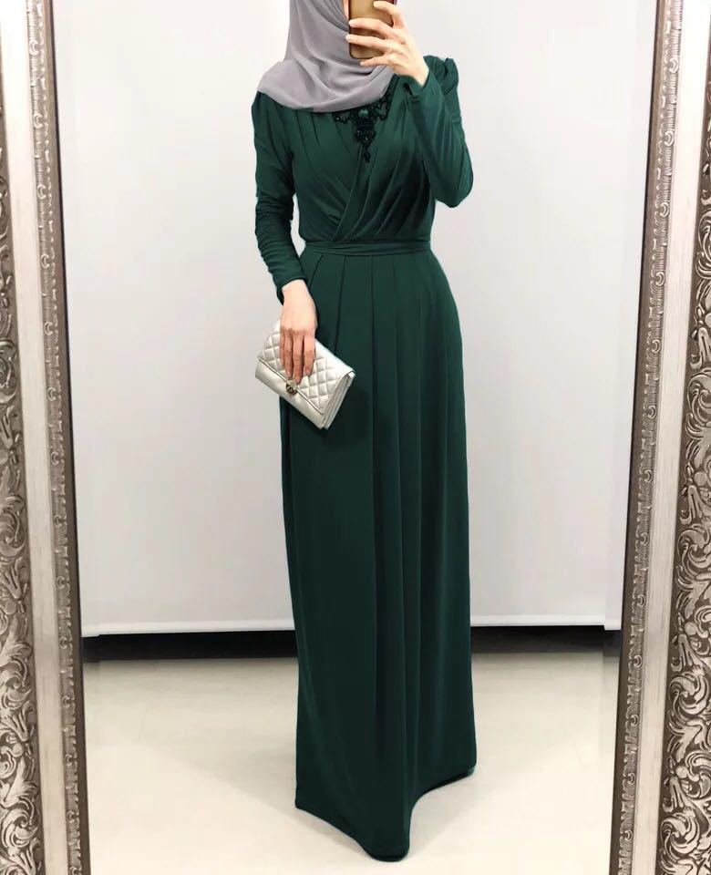 Flowy milk silk abaya dress in green, featuring long sleeves and a flattering silhouette, perfect for modest elegance.